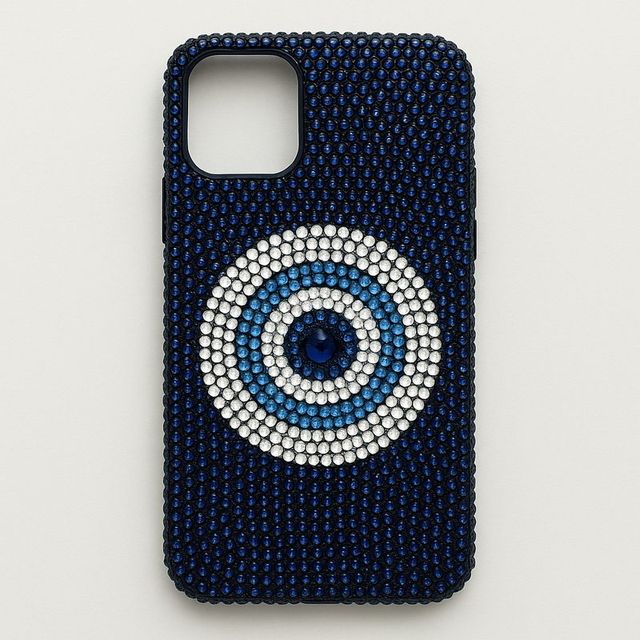 A navy phone case with a blue and white evil eye